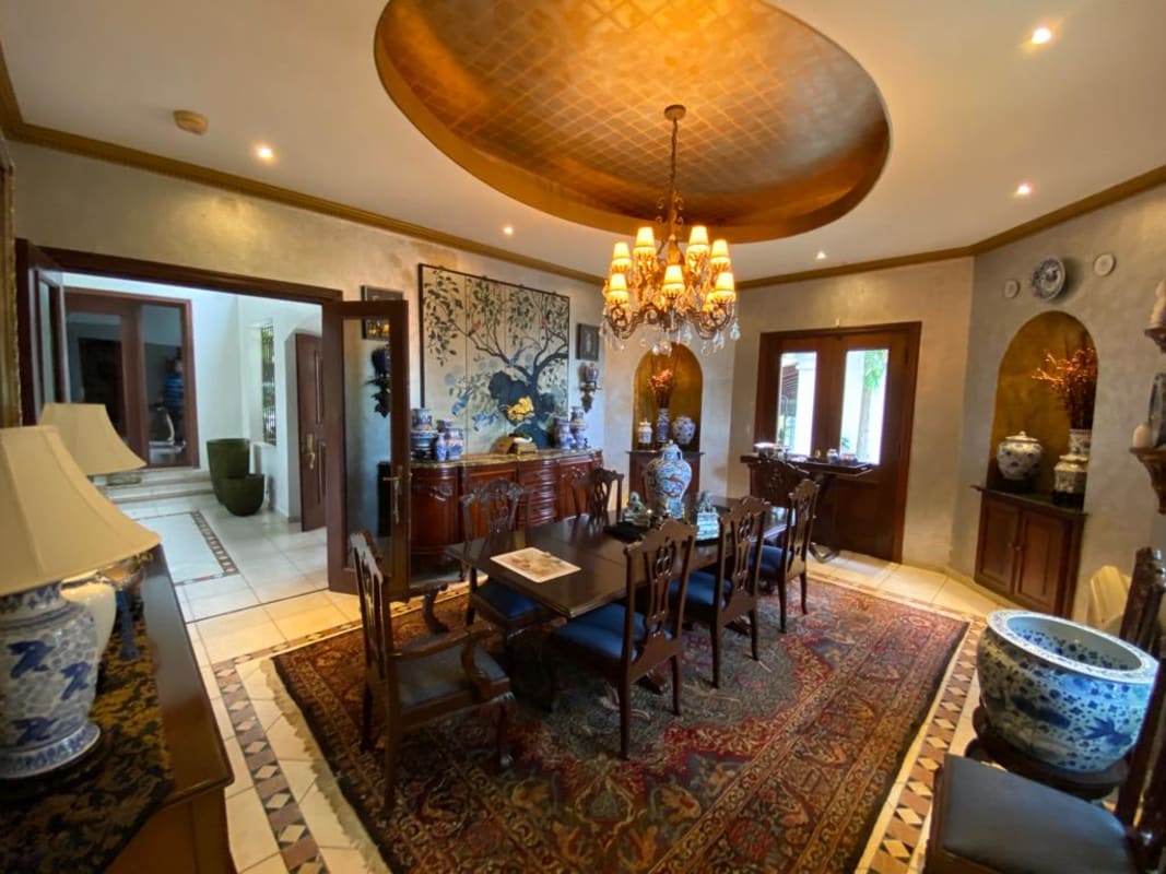 Entertainment game room with billiard table, glass wall garden view, modern lighting in Loma Alegre mansion Panama City