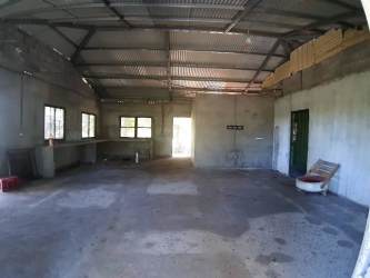Spacious unfinished interior with concrete flooring ideal for workshop or garage in rural Chiriquí