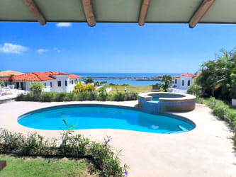 Spacious open living space with high ceilings, garden views and coastal design in Vista Mar villa Panama