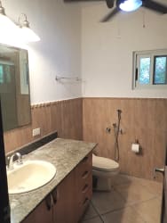 Modern kitchen with granite countertops, wood cabinets, stainless appliances in Vista Mar villa Panama