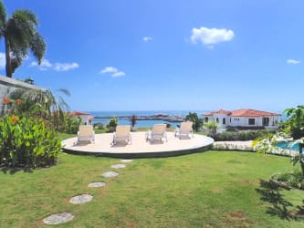 Lush garden backyard with sun loungers, ocean views and tropical landscaping in luxury villa Vista Mar Panama