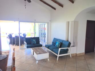 Bright bedroom with ceiling fan, sliding doors to terrace and ocean views in Vista Mar villa Panama