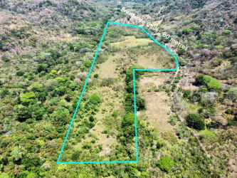 Flat green farmland with surrounding hills Capira ready for fruit trees or cattle