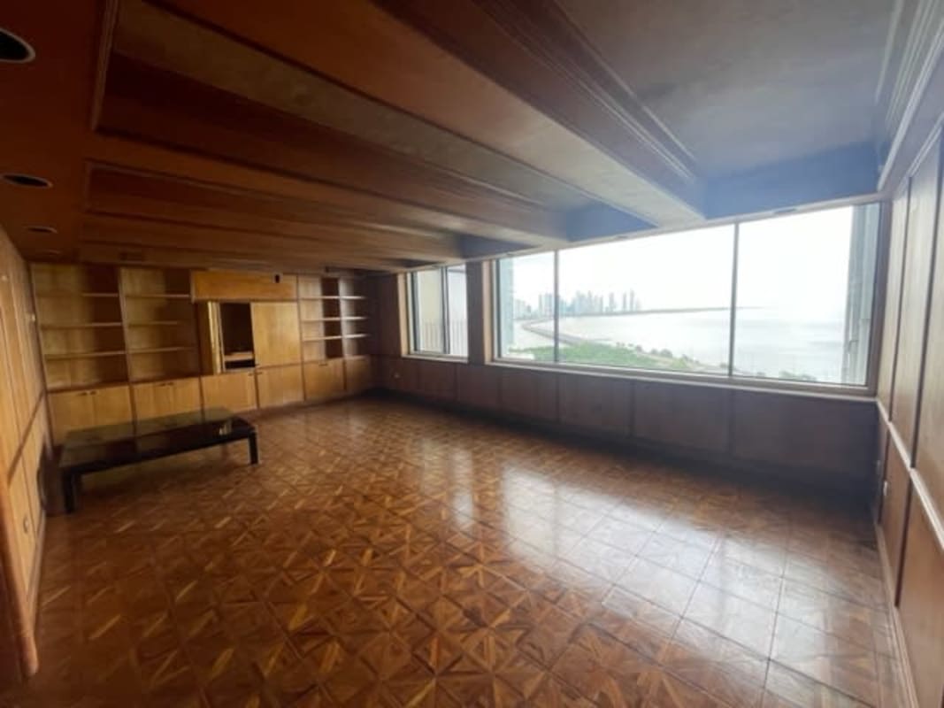Bright formal living space with decorative columns large windows and city views in Coco del Mar penthouse Panama