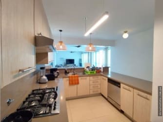Full kitchen with appliances granite counters in PH Balboa I Bijao Beach Club Panama