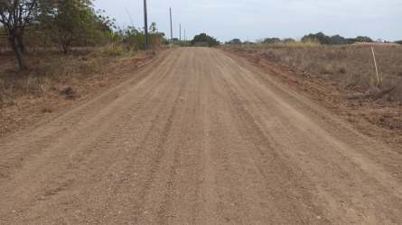 Unpaved dirt road in rural Pedasi leading to residential land plots in Proyecto Libertad Panama