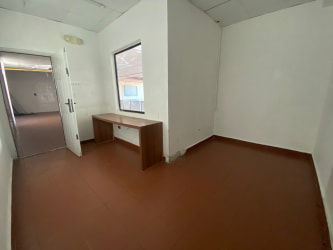 Small empty office study room white walls tiled floor Plaza Más Colón Panama