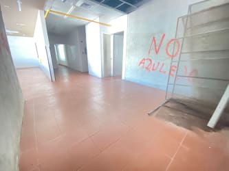 Industrial hallway with exposed ceiling, metal stairs in retail plaza at Colón Panama