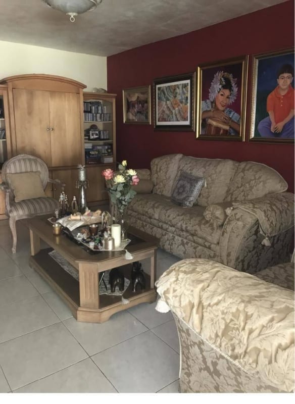 Large living room with beige sofa, entertainment cabinet, burgundy accent wall, Green Valley Albrook Panama