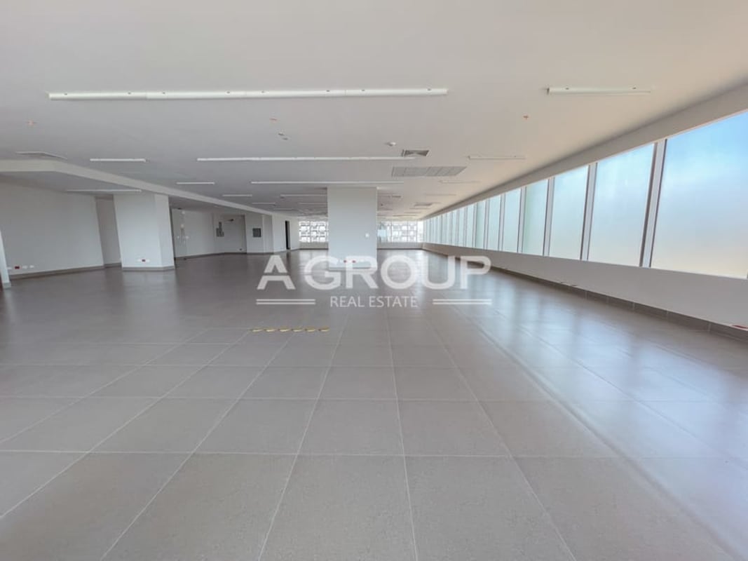 Large open workspace with floor-to-ceiling glass windows in Torre Argos Santa Maria Panama City