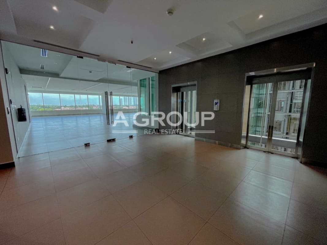 Modern office lobby featuring elevators, glass walls and panoramic views in Torre Argos Panama City