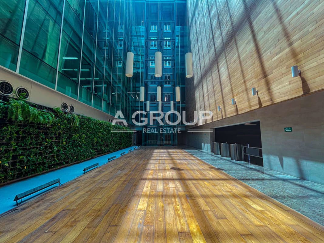 Lobby atrium with vertical garden wall and natural finishes Torre Argos Panama