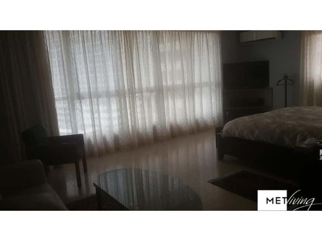 Dining room with large wood table, pendant light PH Marble Tower Panama