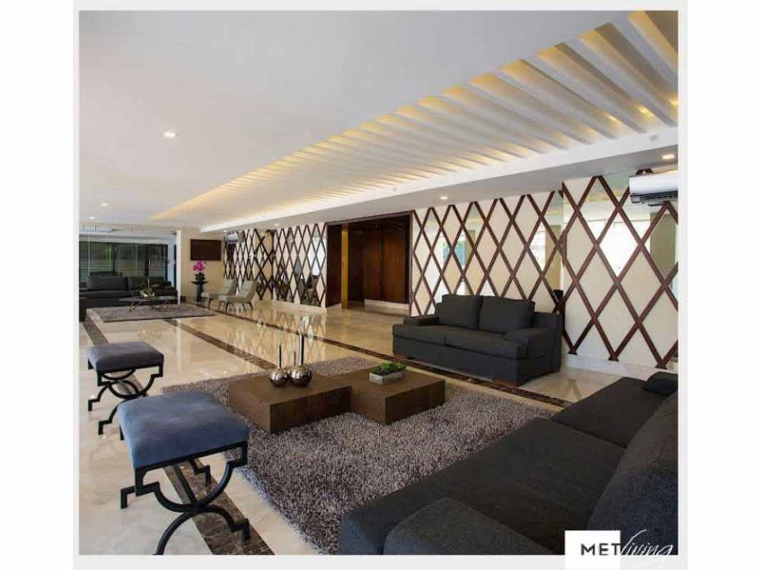 Modern condo lobby with geometric wall design, marble floors, stylish decor at PH Met Village Carrasquilla Panama