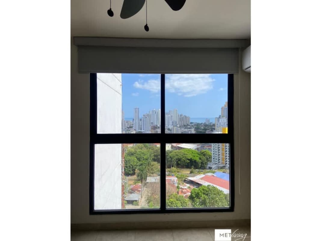 Living area with large window, open plan, tile floors at PH Met Village Carrasquilla Panama