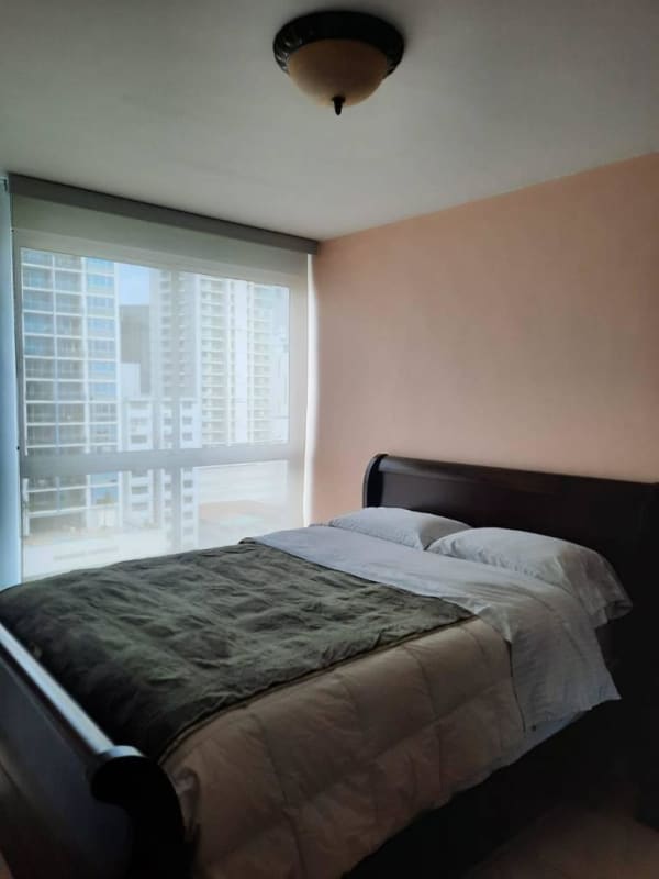 Bedroom with large window and minimal decor at PH El Cangrejo Panama