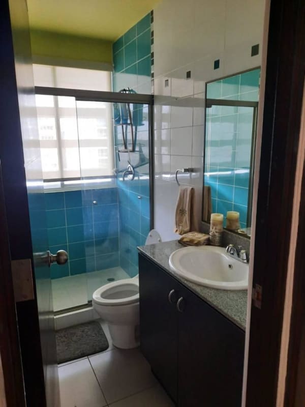 Bathroom with blue tile walls glass shower at PH El Cangrejo Panama
