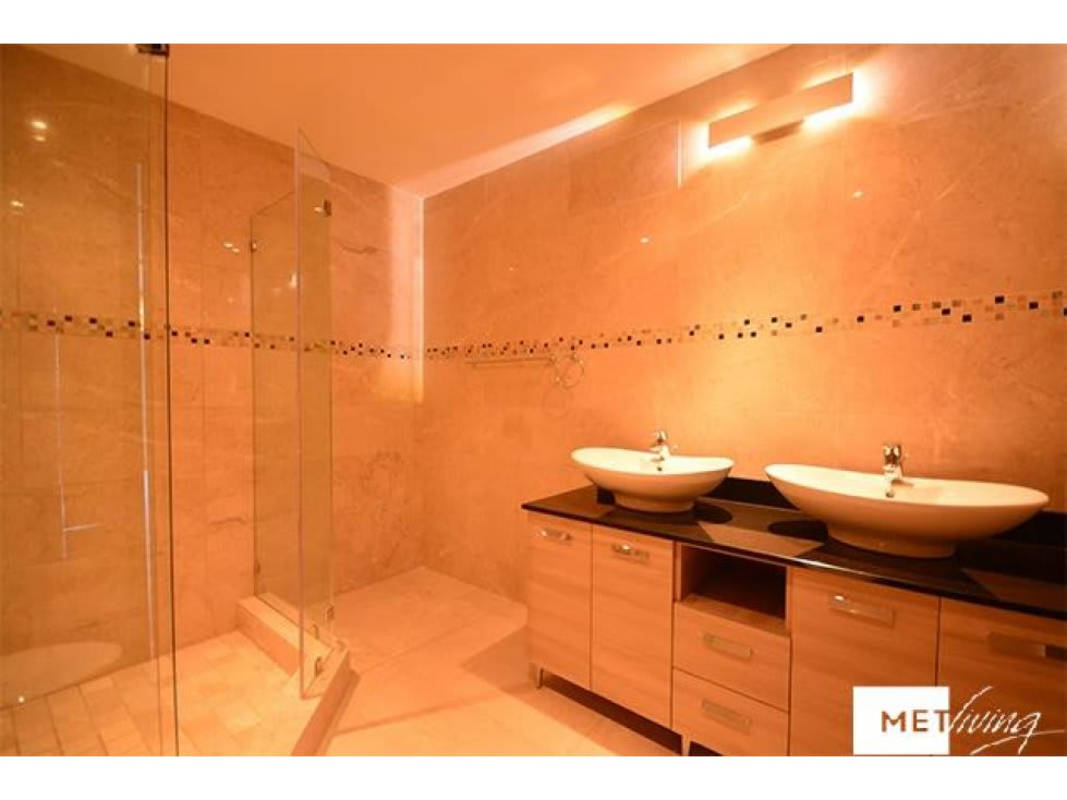 Granite countertop kitchen with appliances and wood cabinetry in Grand Tower Punta Pacifica