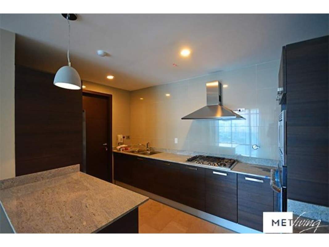 Open living room with marble floors and panoramic windows overlooking Punta Pacifica skyline and Pacific Ocean