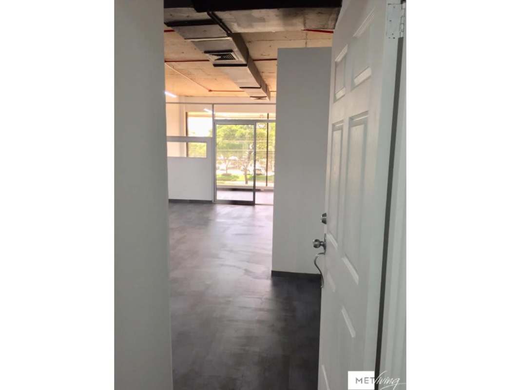 Office entry with glass doors, exposed ceiling, natural light inside PH BICSA Financial Center Panama