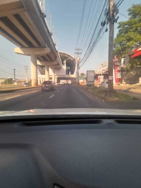 Elevated metro tracks and roadside shops near Villa Lucre La Castellana Panama