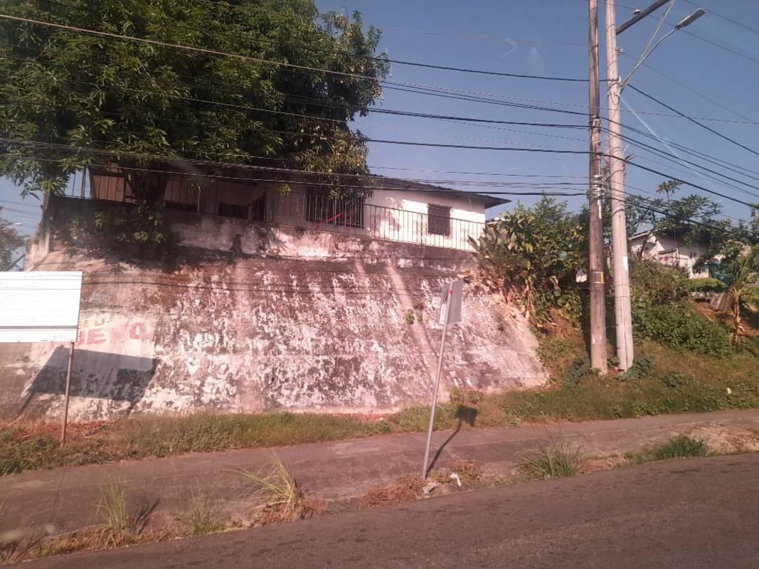Residential house on elevated slope with concrete retaining wall in Villa Lucre Panama
