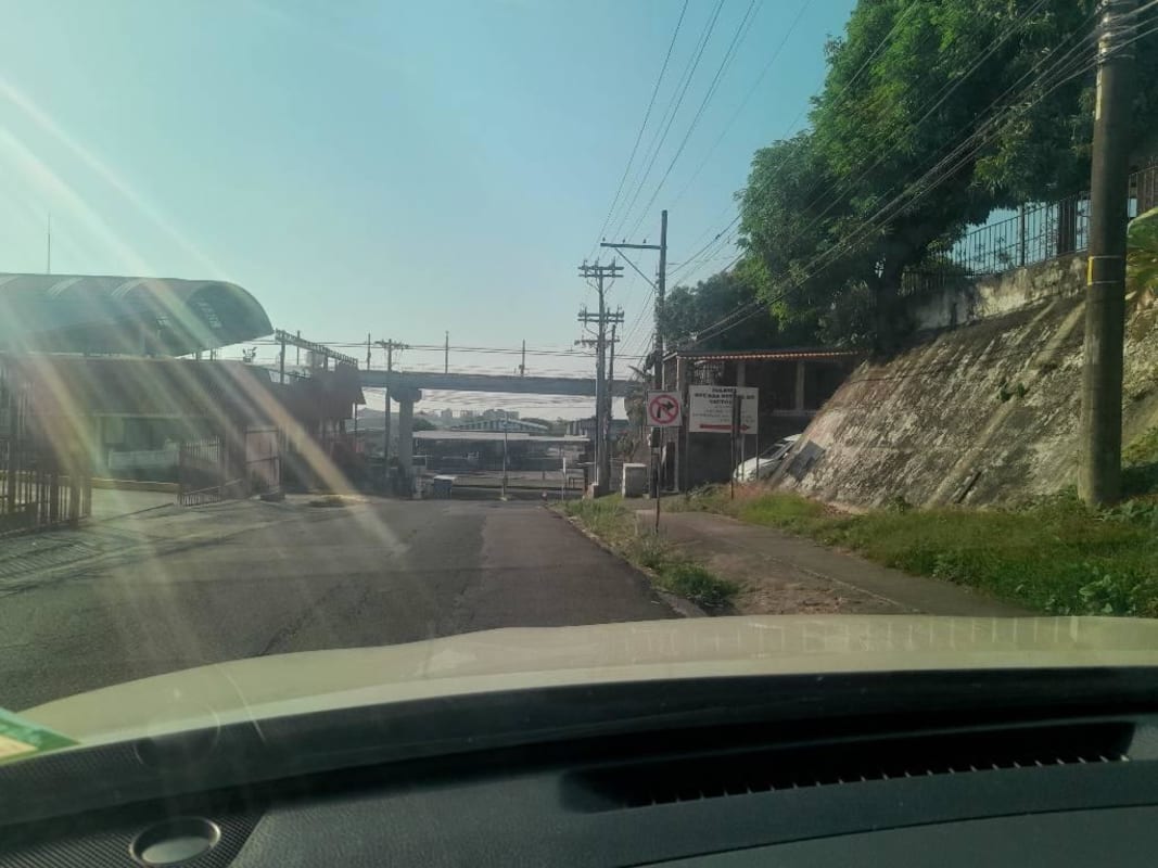 Entrance with gate, security booth, road and greenery Villa Lucre Panama
