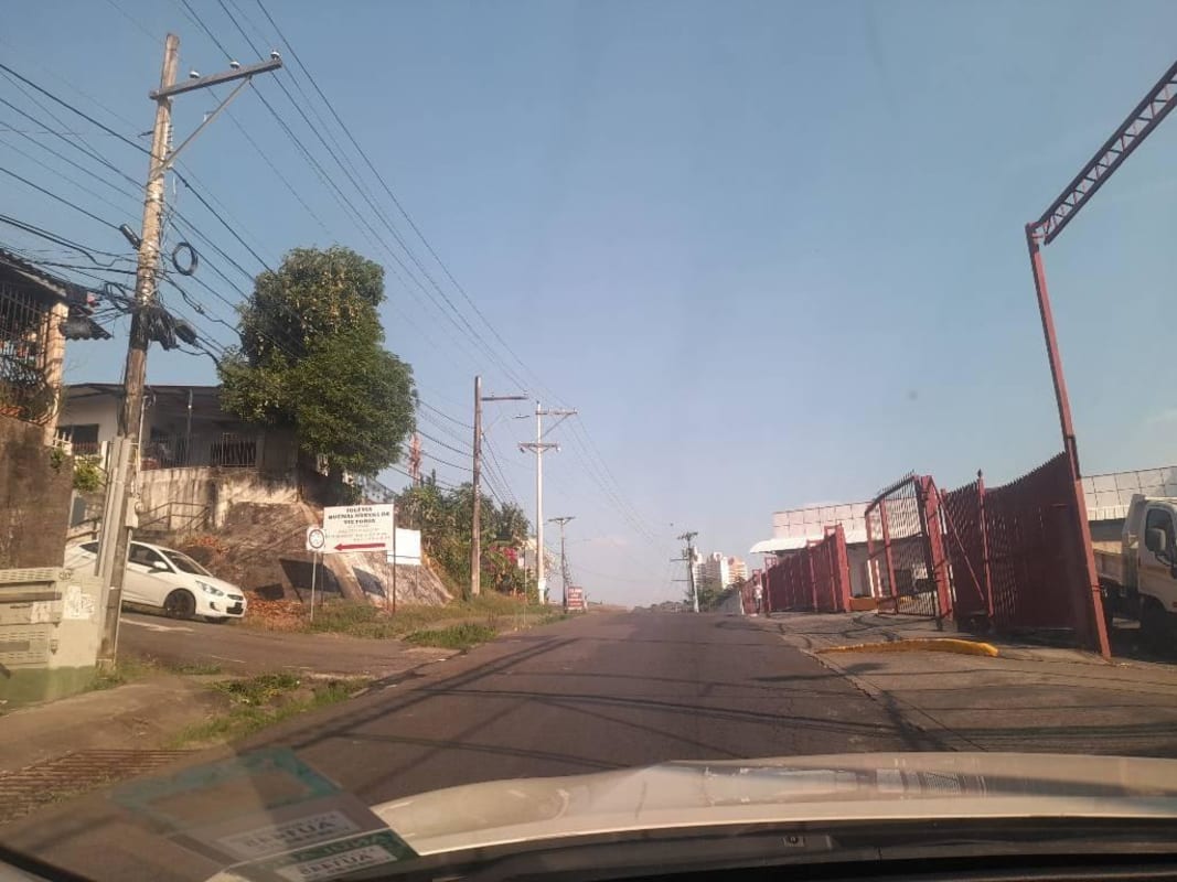 Urban roadside with fences, commercial properties and power lines Panama City