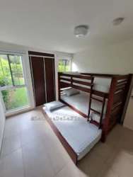 Bedroom with built-in closet, window and tile floors in furnished beach home Las Lajas Panama