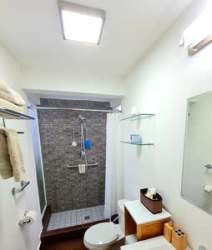 Bathroom with tiled walk-in shower and modern fixtures in furnished beach house Las Lajas Panama