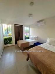 Bedroom with twin beds, garden view windows and closet at Las Lajas Beach Residences Panama