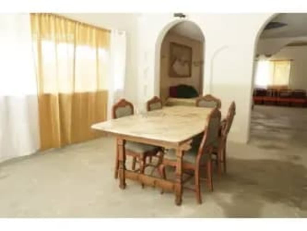 Bedroom with arched doors, neutral decor, framed artwork in Albrook Claytoon home for sale