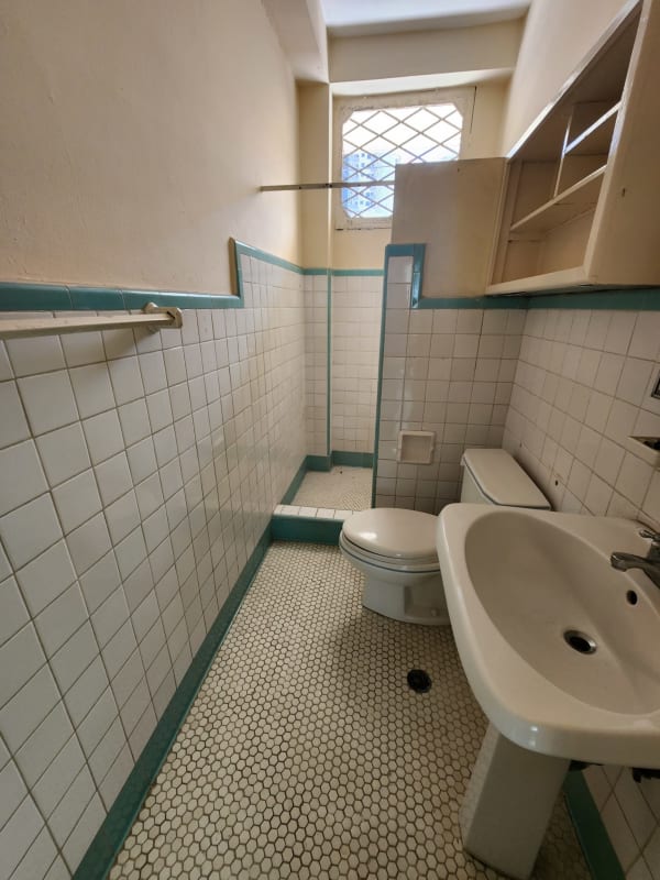 Office bathroom with walk-in shower, pedestal sink, tiled walls PH Nova Tower El Cangrejo Panama