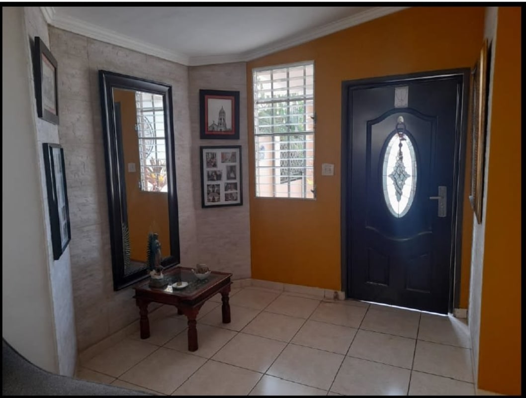 Front foyer with orange accent wall house for sale Brisas del Golf Panama