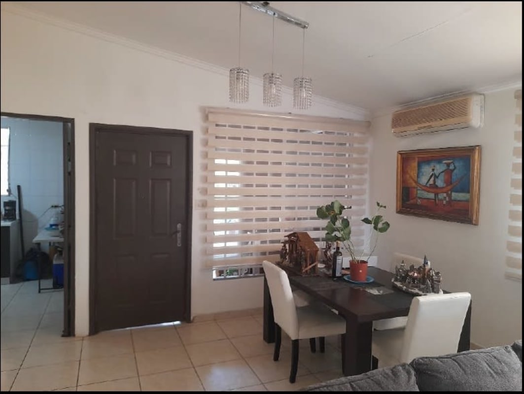 Dining room with window AC tiled floor in house for sale Brisas del Golf Panama