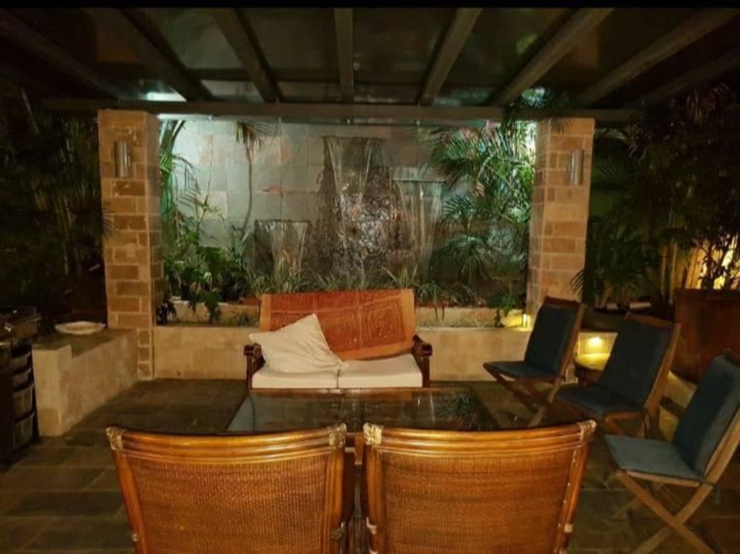 Large elegant living room space with marble floors, big windows, tropical garden views in Costa del Este