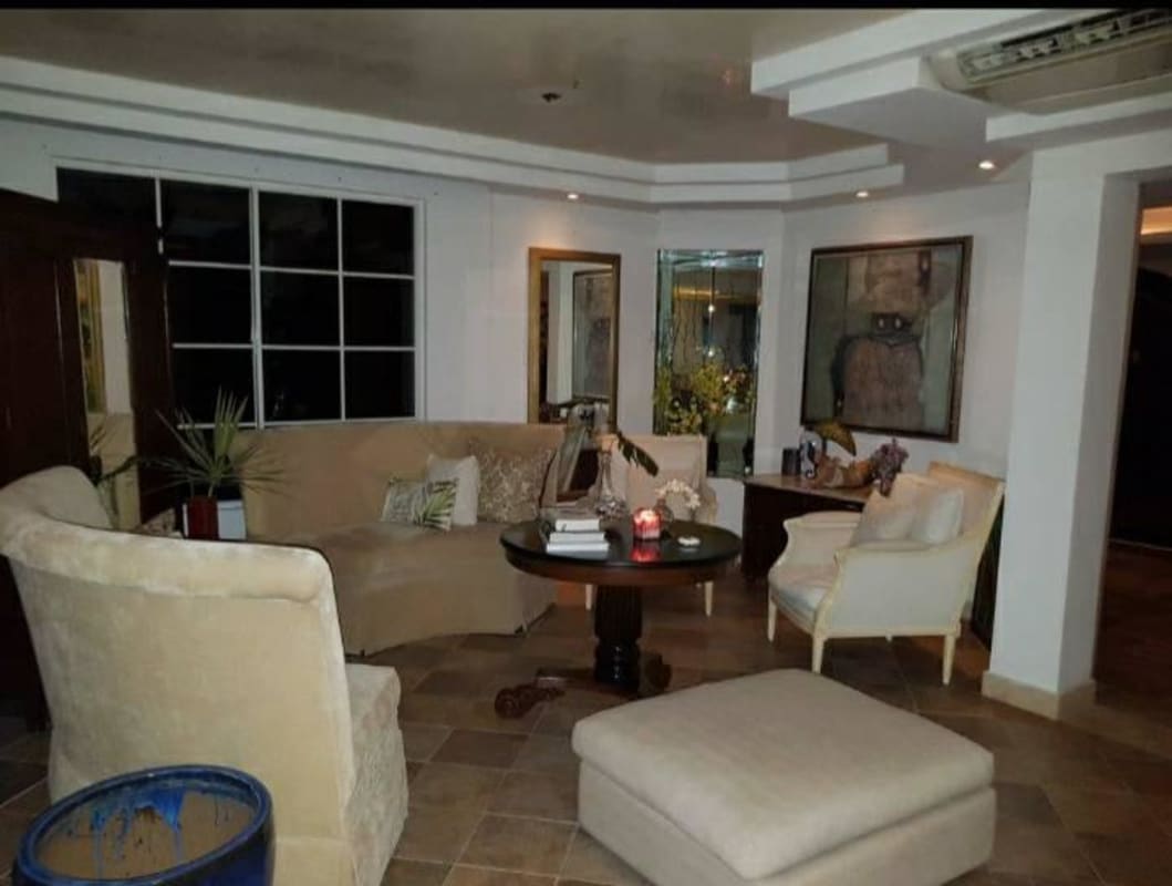 Beautiful private swimming pool with sunbeds surrounded by tropical landscaping in Costa del Este Panama