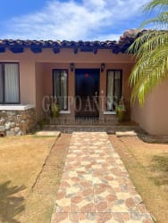 Large covered terrace overlooking backyard garden in Cubitá home Chitré Panama