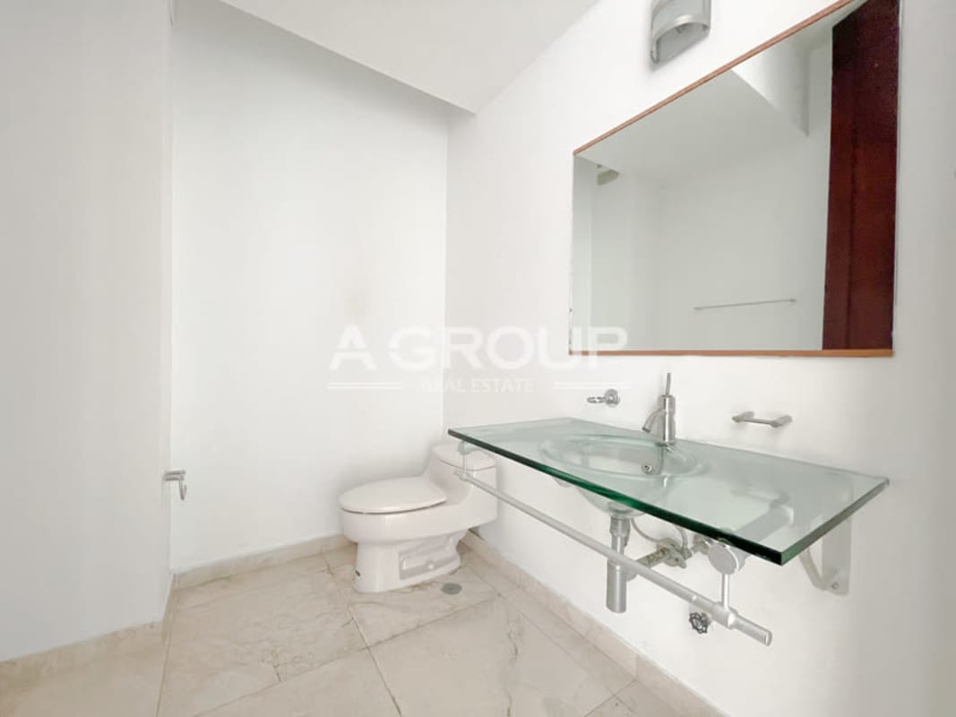 Large master suite with floor-to-ceiling windows offering ocean views in PH Aqualina