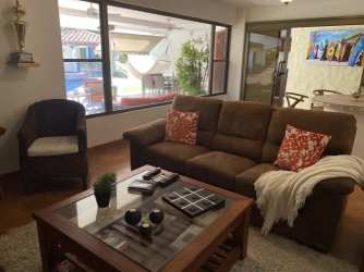 Bedroom with two beds, blue curtains, fan, tropical decor Punta Barco Estate Panama