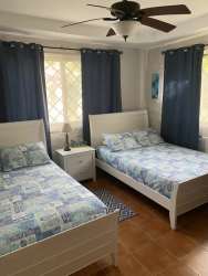 Bright open living area with large windows and brown sofa Mediterranean villa Punta Barco