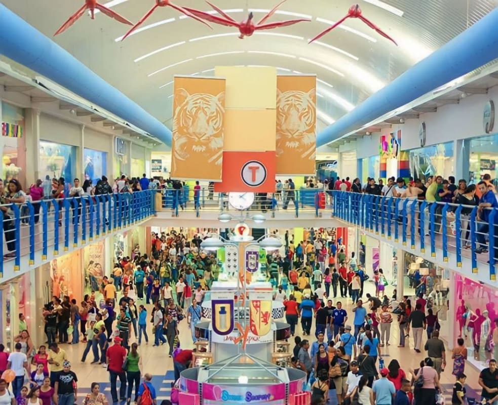 View inside Albrook Mall upper level Dolphin Hallway bustling with shoppers, colorful stores and banners