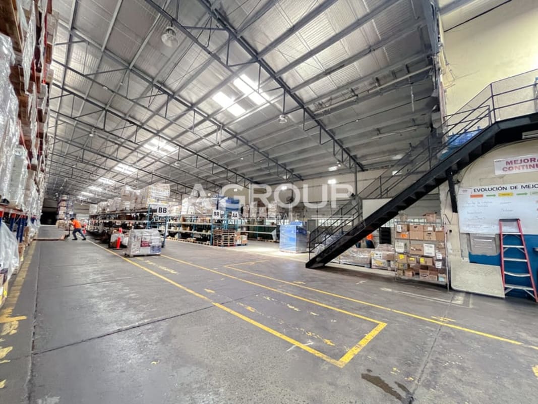 Warehouse interior with mezzanine steel stairs and metal racking at industrial park Tumba Muerto Panama