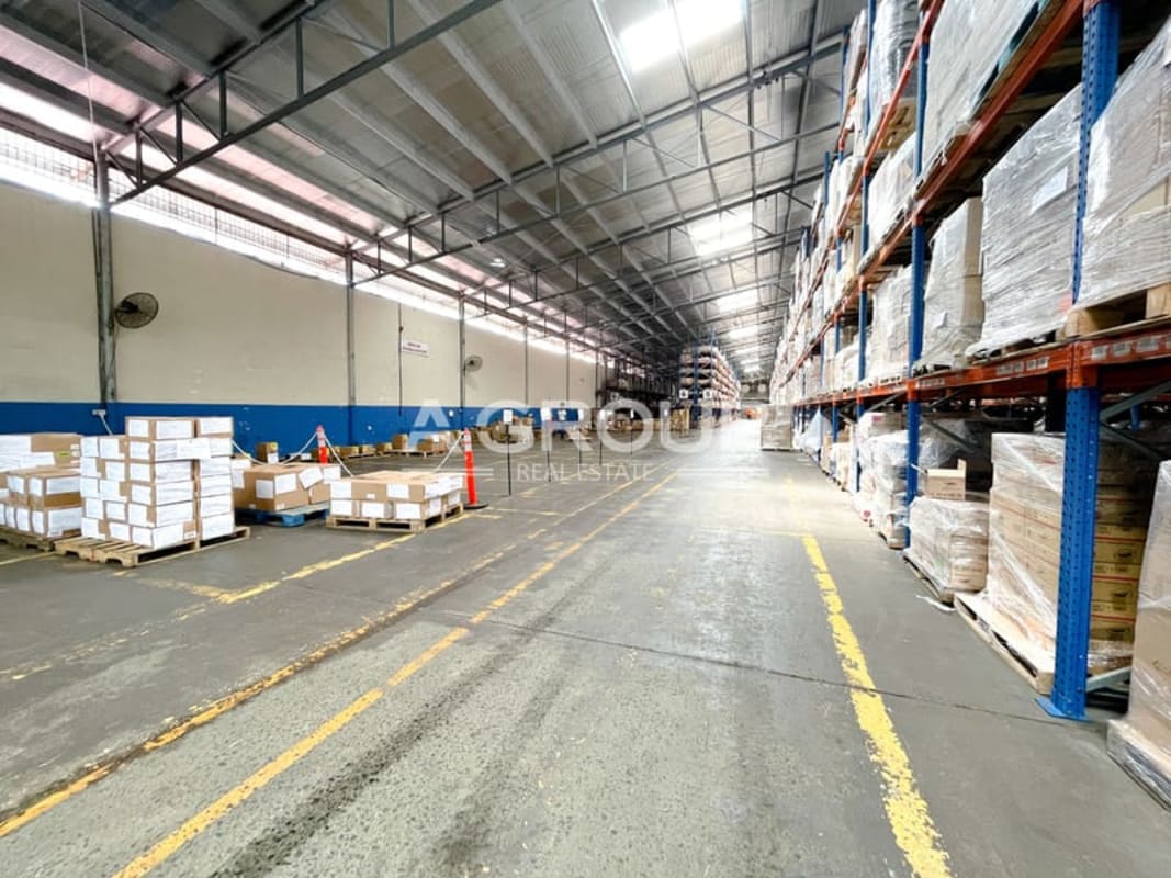 Vast industrial warehouse interior with tall shelving racks for pallets and goods in Tumba Muerto Panama