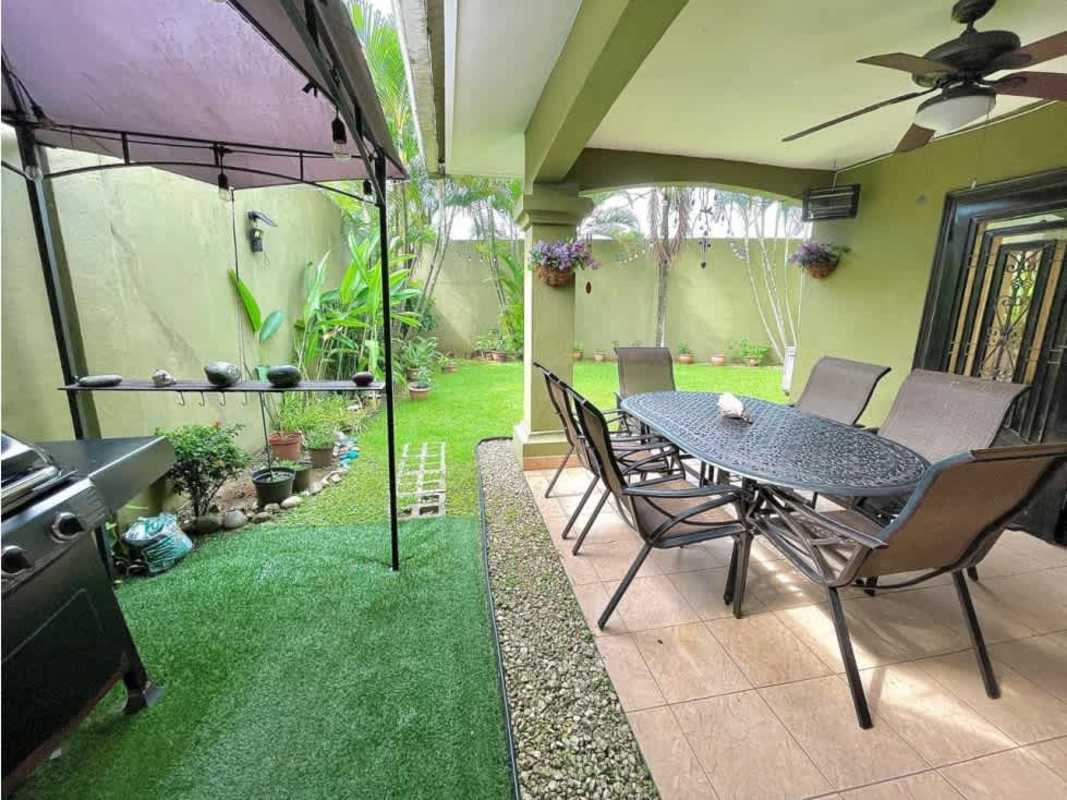 Outdoor covered patio overlooking landscaped garden lot at PH Paseo Dorado
