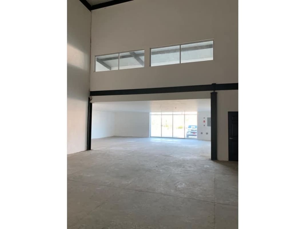 Warehouse exterior facade with parking and large rolling door at Tocumen Panama