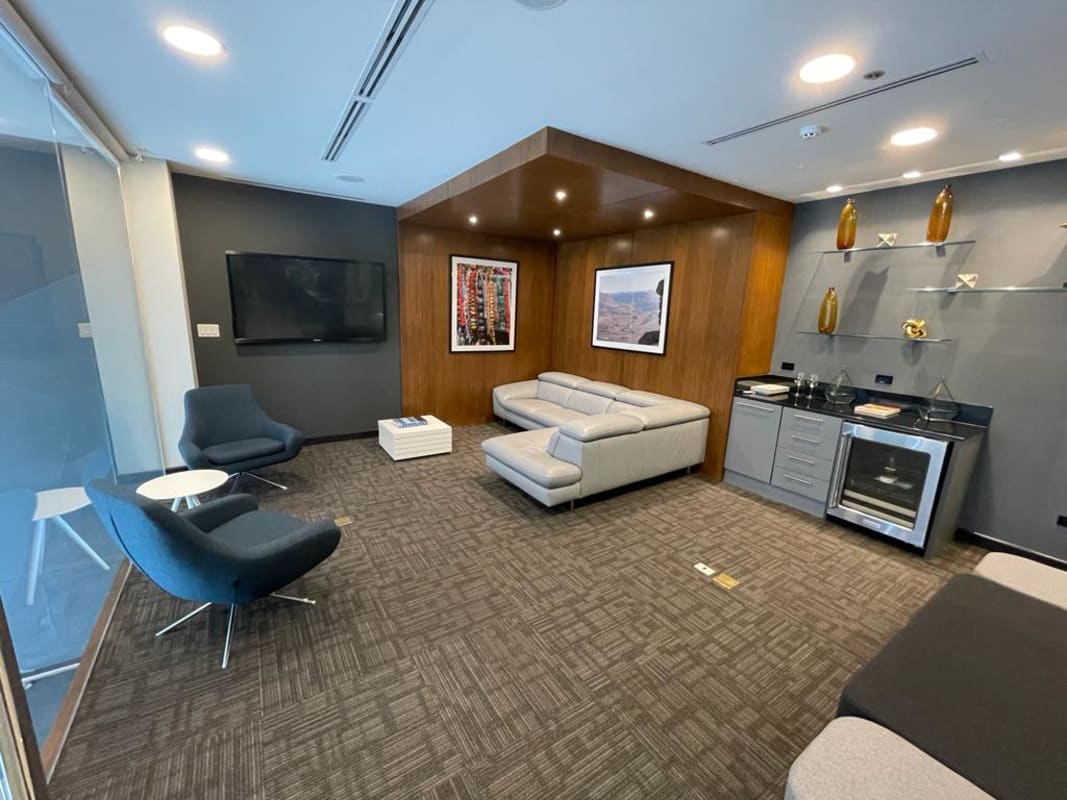 Business lounge with modern sofa, armchairs, TV and minibar in Llano Bonito Business Center Panama