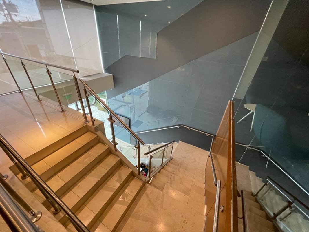 Interior staircase with glass and metal railings in Llano Bonito Business Center