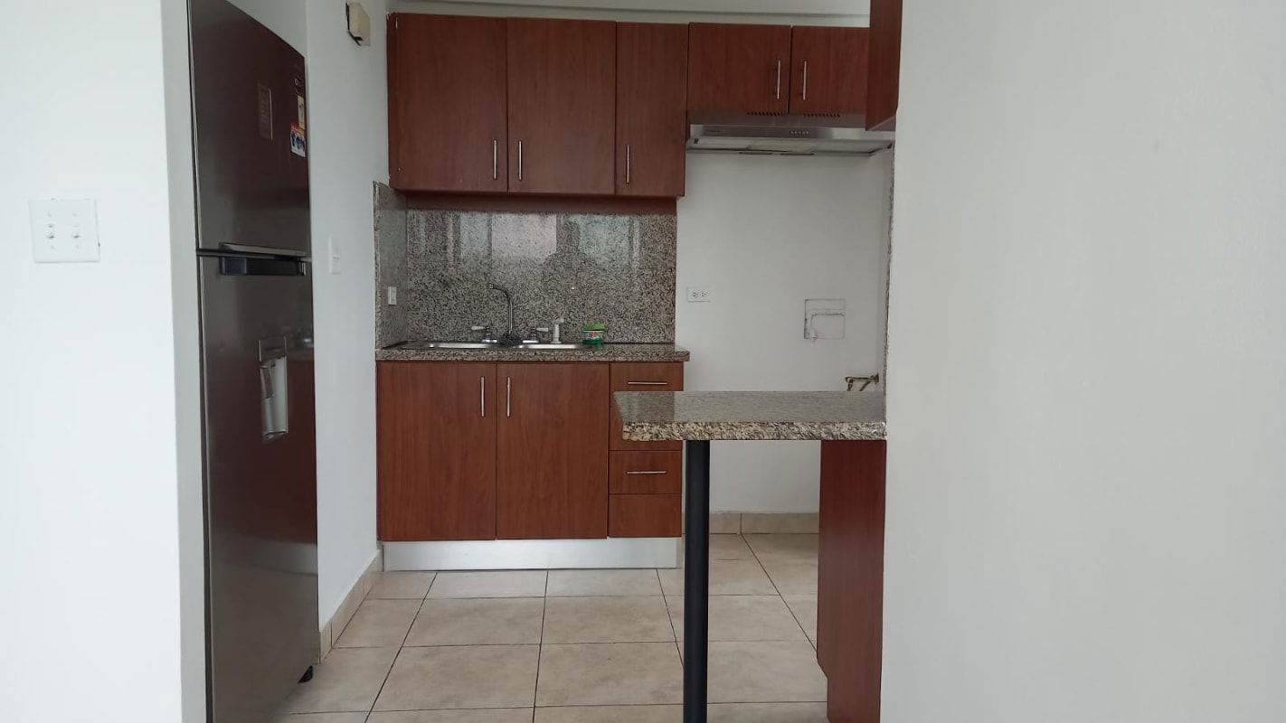 Living room with large windows and access to balcony at PH Green Bay Condado del Rey Panama City