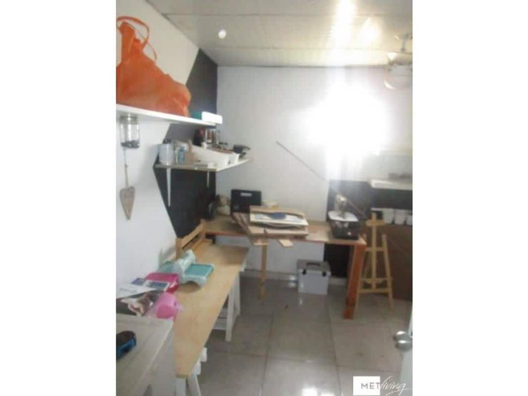 Living room with accent wall sectional sofa TV Islas Montelimar house La Chorrera Panama